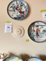 Two upper plates on wall showing Chinese garden scenes