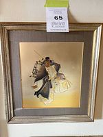 Front view of framed metallic gilded samurai print showing artwork, frame, mat, and signature.