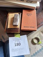 Lighter, box top, warranty card and inner tray grouped together