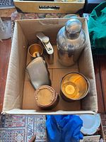Entire set inside box showing shaker, flask, jigger, two collapsible cups with leather wraps
