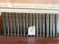 Spines of all 18 volumes lined up in order showing titles, imprint and volume numbers