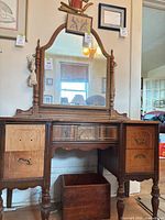 Front view showing entire vanity, drawer configuration, missing drawer fronts and attached mirror