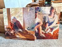 Both paintings side-by-side on carpet showing overall fronts