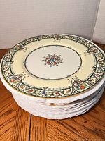 Stack of twelve Chantilly dinner plates showing rim design