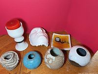 Group shot of all eight tabletop pieces on wooden surface