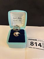 Both rings displayed in blue Vincent Jewelers box, lot tag visible