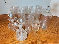 Group view of decanter, two cruets and eight glasses