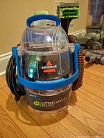 Front view of Bissell Little Green Pet Pro with hose, tool and cord visible