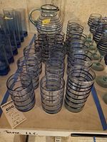 Group view of pitcher, short tumblers, tall tumblers, stemmed glasses