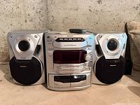Front view of Panasonic SA-AK18 unit flanked by two matching speakers