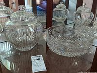 Jar and bowl together on glass shelf, shows overall form and cuts
