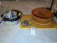 Overview of all items: stoneware pot with lid, wooden bowl, wooden cutting board, metal crab accent