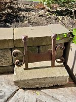 Front view of cast iron boot scraper mounted on concrete block