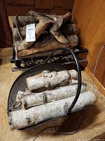 ceramic faux logs on metal grate with ash pan in foreground