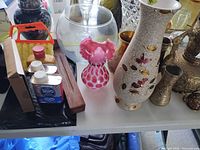 Overall lot showing mix of vases, brass items, glass pieces and cleaning supplies