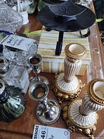 Overview of assorted candlesticks, fragrance lamps and candle holders on tabletop