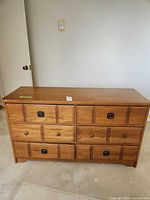 Front view showing six drawers, pulls, overall finish