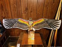 Wide view showing eagle kite spread on wall, Mirado mantel clock beneath