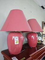 Both pink ceramic lamps on dresser