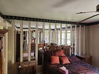 Wall with 14 vertical rectangular mirror panels behind bed