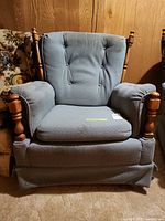 Front view of blue-gray armchair with wood spindle accents
