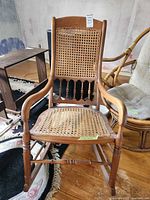 Front view of bentwood rocking chair showing cane seat, cane back, turned spindles and curved runners