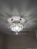 Chandelier illuminated showing crystal prisms and light diffusion