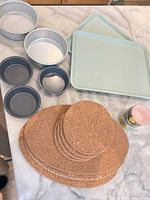 Overall lot showing trivets, pans, trays, cupcake liners