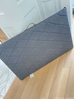 Front view of gray quilted rectangular dog bed