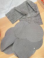 Round placemats and folded runner on surface