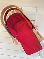 Top view of sled showing red seat liner inside wood frame