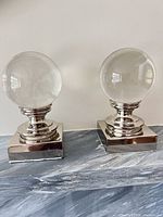 pair of glass ball sculptures front view