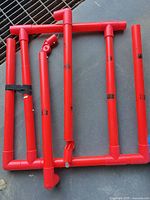 Collapsed red PVC pipe frame showing all sections and connectors