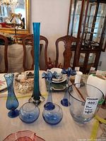 Overview of all blue and teal glass pieces on table