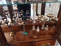 Full set inside cabinet showing both candelabra, three compotes and two shakers