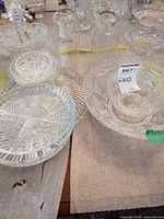 Group view of clear pressed and cut glass bowls, divided dish, platter