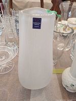 Front view of vase showing frosted finish and brand label