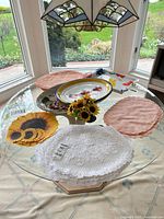 Overall view of placemats, ceramic tray and sunflower centerpiece on glass table