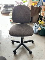 Front view of grey fabric office chair on black plastic base with casters