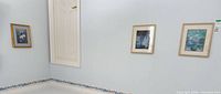 Overview of three framed prints hanging on wall