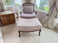Full view of armchair and ottoman showing style, upholstery and overall condition