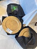 Three bags containing stacks of gold embossed charger plates