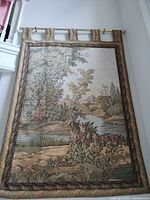 full view of tapestry hanging on wall showing entire design, border and tab loops