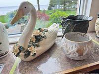 swan planter, leaf pot and round pot on windowsill