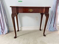 Front view of mahogany Queen Anne console table showing drawer and cabriole legs