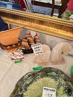 Overall lot showing stone horse head bookends and multiple sailboat figurines