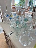 Group view of assorted stemmed glasses, bowls and holders on counter