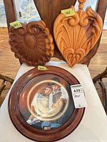 All three wood wall decor items grouped on chair