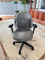 Front view of grey Nightingale office chair with lumbar pillow and armrests