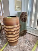Both vases shown side by side on countertop for size and pattern reference